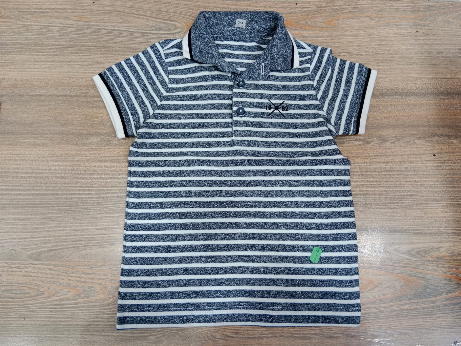 Boys navy striped polo shirt - flat lay